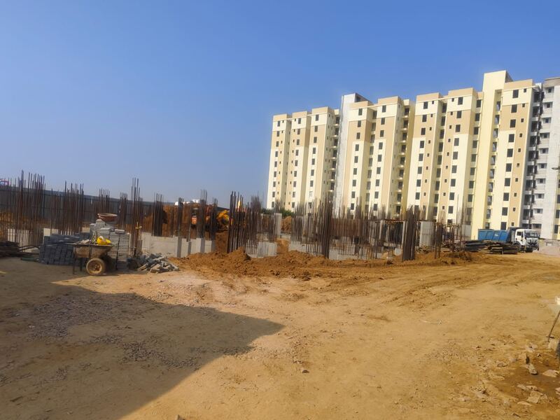 Completed residential blocks beside an active section of the site